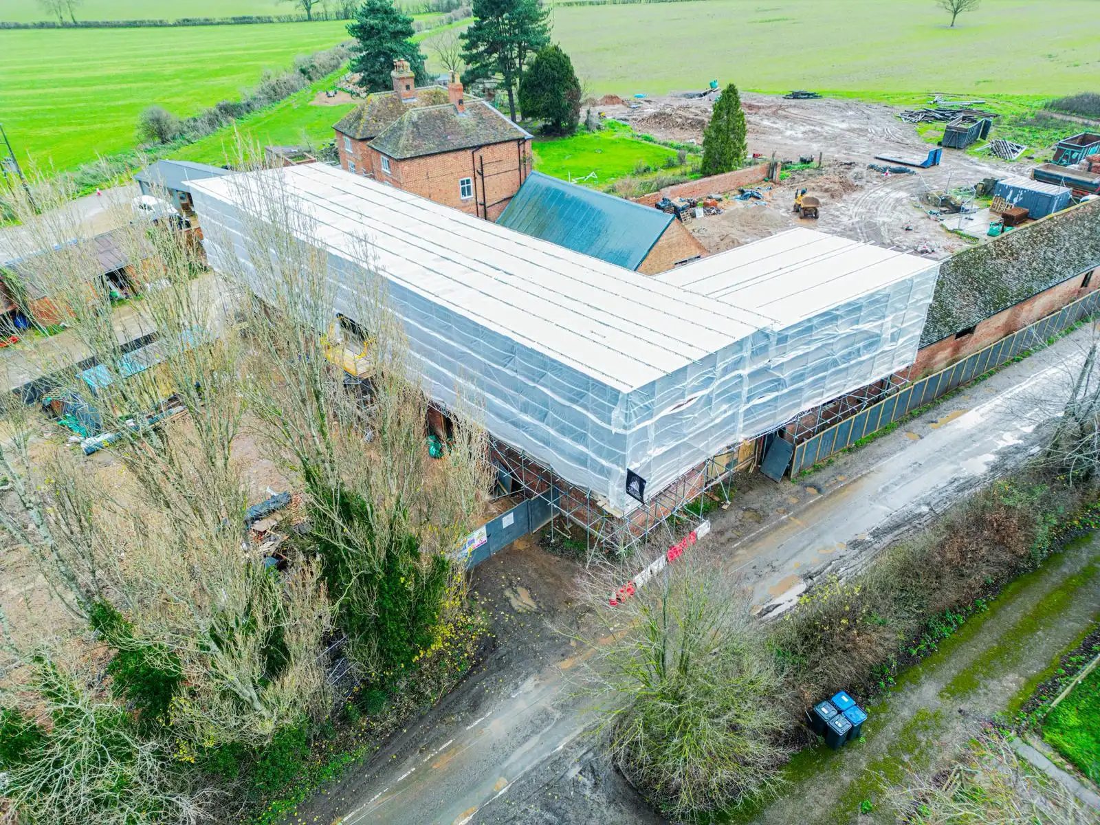 Aerial view of temporary roof scaffolding beside a rural road