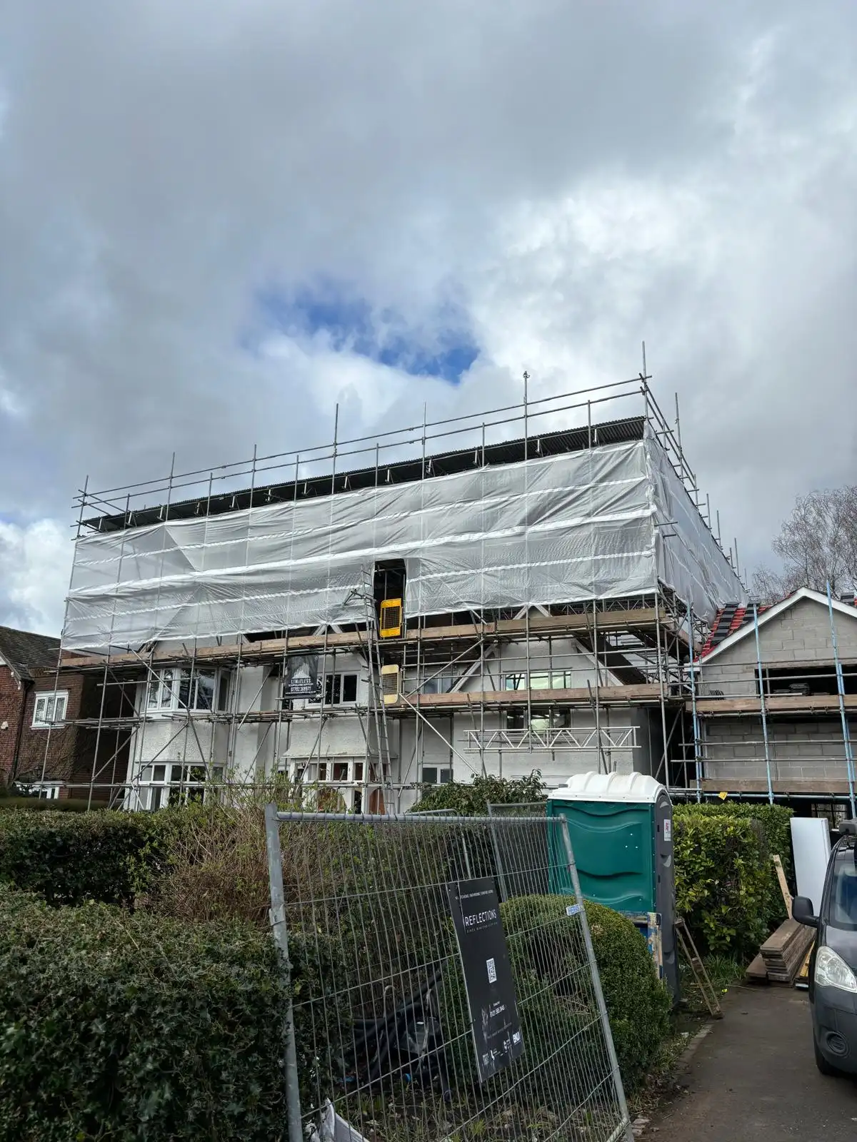 Scaffolding and weather sheeting around a residential house
